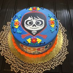 a cake decorated with sugar skulls and flowers