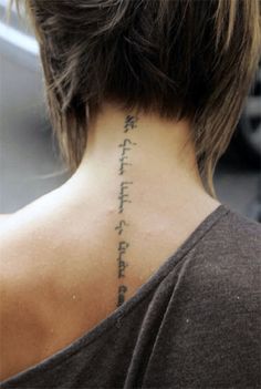 the back of a woman's neck with an inscription on it that reads,