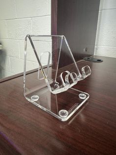 an acrylic display case sitting on top of a wooden desk