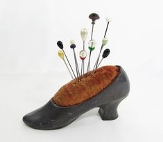 a shoe shaped object with pins sticking out of it