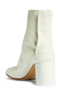 Inspired by the Japanese tabi sock, this iconic split-toe boot is made from supple leather and set on a cylindrical heel that keeps the palette monochromatic. Style Name:Maison Margiela Tabi Boot (Women). Style Number: 6074697. Modern White Heeled Boots With Sculpted Heel, Spring Calf Leather Heeled Boots Medium Width, Spring Heeled Boots In Calf Leather, Modern Calf Leather Heeled Boots For Spring, Medium Width Calf Leather Heeled Boots For Spring, Split Toe Boots, Monochromatic Style, Tabi Boots, Tabi Socks