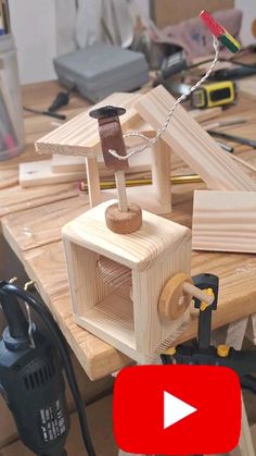 a video demonstrating how to make a wooden toy house with woodworking tools on the table