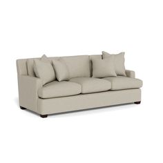 an image of a couch with pillows on the top and bottom half, in beige linen