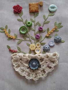 a close up of buttons and flowers on a cloth