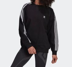 The adidas beloved classic gets updated with an oversized fit for extra comfort. The Adicolor Oversized Sweatshirt is complete with the iconic 3-Stripes down long sleeves, a crew neckline, adidas branding, and ribbed trimming. Relaxed fit Ribbed crewneck 100% cotton French terry Soft feel Drop shoulders Imported Product color: Black Product code: GN2783 Adidas Sleek, Oversize Sweatshirt, Keep It Cool, Lock Up, Cotton Farming, Adidas Sweatshirt, Adidas Hoodie, Plastic Waste, The Deal