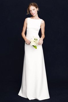 a woman in a white dress holding a bouquet