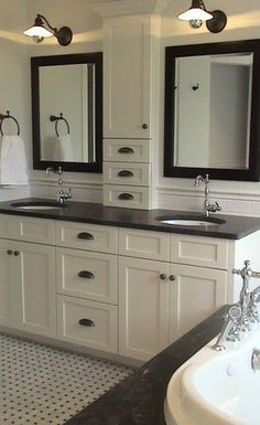 a bathroom with double sinks and two mirrors on the wall next to a bathtub