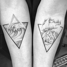 two people with tattoos on their legs and one has a wave coming out of the mountain