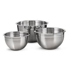 four stainless steel mixing bowls on a white background