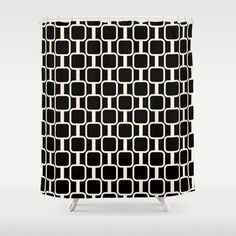 a black and white shower curtain with an abstract design in the middle, on a gray background