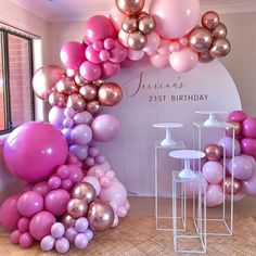 the balloon arch is decorated with pink, purple and gold balloons for a 21st birthday party