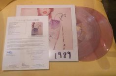 an autographed pink vinyl album is on display