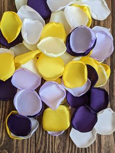 purple, yellow and white felt flowers on a wooden surface