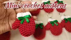 crocheted keychains with red and white knitted strawberrys hanging from them