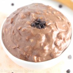 a white bowl filled with chocolate pudding on top of a table