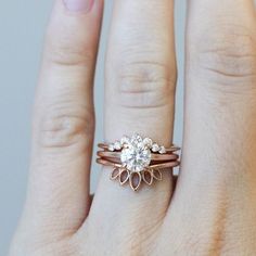 a woman's hand with a ring on it and a diamond in the middle