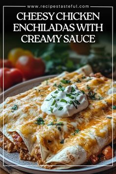 cheesy chicken enchiladas with creamy sauce on a plate next to tomatoes