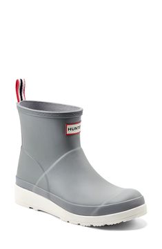 This contrast-sole version of a classic Hunter rain boot retains all the style and waterproof practicality of the original in an abbreviated silhouette. Waterproof: protects against rain, puddles and slush to keep feet dry in wet conditions 1 1/4" platform 5" shaft Pull-on style In hot or humid weather, natural latex rubber releases a protective wax film; simply wipe it off with a damp cloth Rubber upper/textile lining/rubber sole Imported Weatherproof Casual Gray Boots, Gray Weatherproof Casual Boots, Sporty Gray Boots With Rubber Sole, Waterproof Functional Gray Boots, Short Rain Boot, Grey Heron, Rain Boots Women, Short Rain Boots, Humid Weather