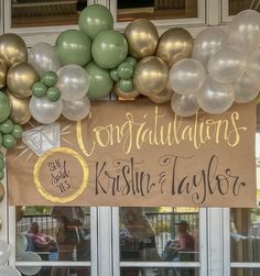 balloons and streamers decorate the front door of a restaurant for guests to sit at