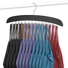 an umbrella is hanging on a rack with several colors in it and the hangers are black, white, red, blue, green, yellow