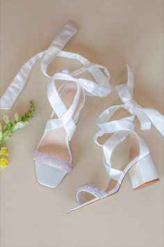 the bride's shoes are tied up and ready to be put on her wedding day