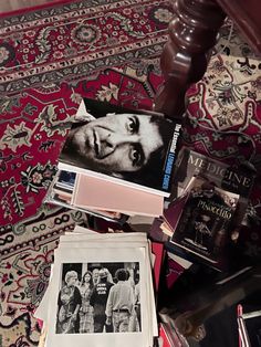 a pile of books sitting on top of a rug