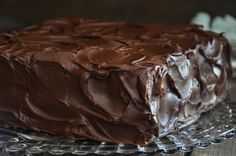 a chocolate cake sitting on top of a glass plate