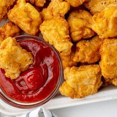 fried food with ketchup and sauce on a plate