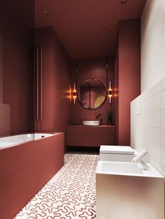 a large bathroom with red walls and white flooring, along with an oval mirror above the bathtub