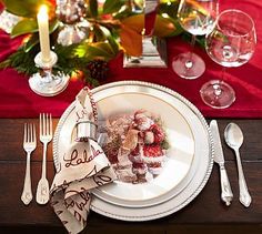 a white plate topped with food on top of a wooden table next to silverware