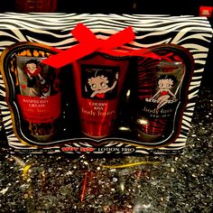 the body lotion gift set includes two bottles and a red bow on it's head