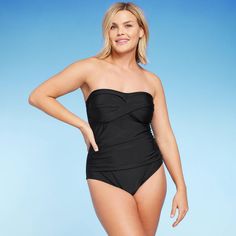 This Twist-Front Bandeau Classic One-Piece Swimsuit with Tummy Control from Kona Sol™ is made from soft fabric with added spandex for stretchy comfort. The sleeveless swimsuit fashioned in a classic bandeau silhouette in black will have you standing out from the crowd. The twist-front accent adds style, the tummy control feature gives you a flattering look, and the crisscross back ties with keyhole give you an ideal fit every time. Plus, you can choose the level of comfort thanks to the removabl Solid Color Bandeau Tankini With Stretch, Solid Color Stretch Bandeau Tankini, Stretch Bandeau Ruched Tankini, Solid Stretch Bandeau Tankini, Black Strapless Stretch Tankini, Strapless Stretch Swimwear With Lined Body, Strapless Stretch Tankini For Swimming, Fitted Tankini With Wide Waistband For Swimming, Strapless Stretch Bodysuit For Poolside