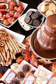 a table topped with lots of different types of food and desserts next to each other