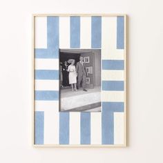 a blue and white striped frame with a man and woman