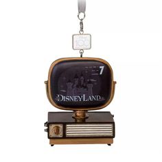 an old fashioned tv keychain is hanging on a white background with the words disneyland land printed on it