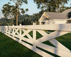 a white picket fence in front of a house with trees on the side of it