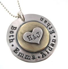 a silver and gold necklace with two hearts on it