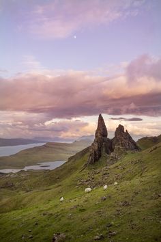 the mountains are covered in grass and rocks