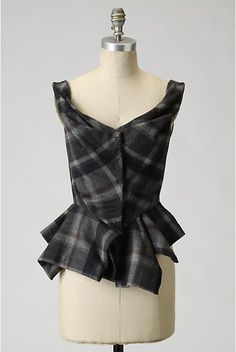 a mannequin wearing a black and grey plaid top