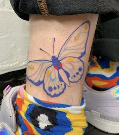 a person with a butterfly tattoo on their leg