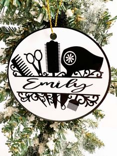 Our personalized hair stylist ornament features hairdresser's name inside a design of hairdryer, comb and curling iron.  Looks great hanging on a Christmas tree in your salon, or makes a great gift for your favorite stylist.  Salon owners, great to order one for each of your staff!  Design is the same on both sides Features black lettering on a white background.   Note Stylist name in the comments  Unbreakable mdf ornament is lightweight and measures 2.83 inches.  Cute to add as a gift tag too!   The image is sublimated directly into the surface, so no peeling or fading! In stock and ready to personalize and ship via First Class US mail Unique Christmas Trees Themes, Burnt Hair, Salon Signs, Laser Cut Wood Crafts, Beautiful Lettering, Wood Burning Art, Christmas Tree Themes, Personalized Christmas Gifts, Tree Decor