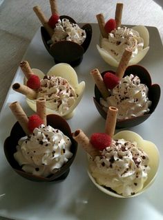 small cups filled with ice cream and toppings on a white platter, ready to be eaten