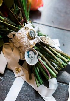 a bouquet of flowers is sitting on the table next to a pair of scissors and ribbon