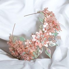 This stunning hair accessory features a princess-style design with a regal 4 cm height, perfect for making a statement. Adorned with delicate blush pink flowers, mint green leaves, and pearlescent accents, it exudes an air of elegance and charm. The accessory's lush floral arrangement and shimmering details make it a perfect choice for brides, bridesmaids, or anyone looking to add a touch of fairy-tale beauty to their special day. DESIGN ♥︎ Each leaf and flower is handmade from varnished wire using the UV resin dipping technique, giving them a unique and durable finish. ♥︎ Mother-of-pearl white color flowers. ♥︎ Available with either white beads or pearls for a refined finish. ♥︎ The highest part of the crown (approx.): 4 cm (1.57 inches) ♥︎ The flowers diameter (approx.): 3-4 cm (1.18-1.5 Resin Dipping, Leaves Crown, Blush Pink Flowers, Crown Pink, Pink Cherry Blossom, Yule Ball, 2nd Year, Pink Cherry, Wedding Tiara