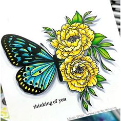 a close up of a card with a butterfly and flowers