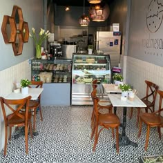 the inside of a restaurant with wooden chairs and tables in front of an ice cream shop