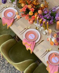 the table is set with pink and orange plates