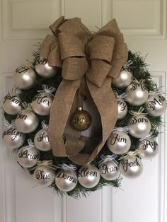 a christmas wreath with ornaments hanging on the front door