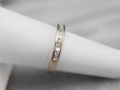 This white gold wedding band is set with a glittering row of square-cut, fine diamonds. The look they create is very 'Deco', and very modern at the same time. Styled for a man or a woman, this is a great piece for a wedding day or stacking ring. Channel settings never go out of style! The effect of one long row of diamonds, one band of glittering bright light, across the finger is always popular and always lovely. The sides of the ring completely encase the diamonds, keeping them safe and secure Modern Formal Eternity Band With Single Cut Diamonds, Minimalist Channel Set Diamond Wedding Ring, Wedding Square Cut Channel Set Rings, Wedding Radiant Cut Channel Set Diamond Ring, Princess Cut Half Eternity Diamond Ring, Radiant Cut Channel Set Diamond Wedding Ring, Formal Half Eternity Princess Cut Band, Princess Cut Diamond Ring For Marriage, Modern Rectangular Diamond Wedding Ring