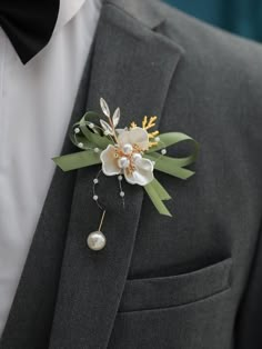 a man in a suit with a boutonniere on his lapel flower